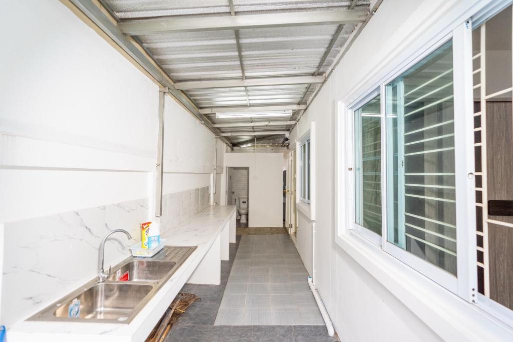 a kitchen with a sink and a window at อรุณวิภา บ้านพักสำหรับครอบครัว อำเภอเมืองหนองคาย in Ban Na Kai