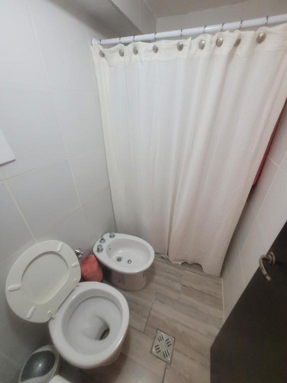 a bathroom with a toilet and a shower curtain at Strategic place, close to everything in Villa Carlos Paz