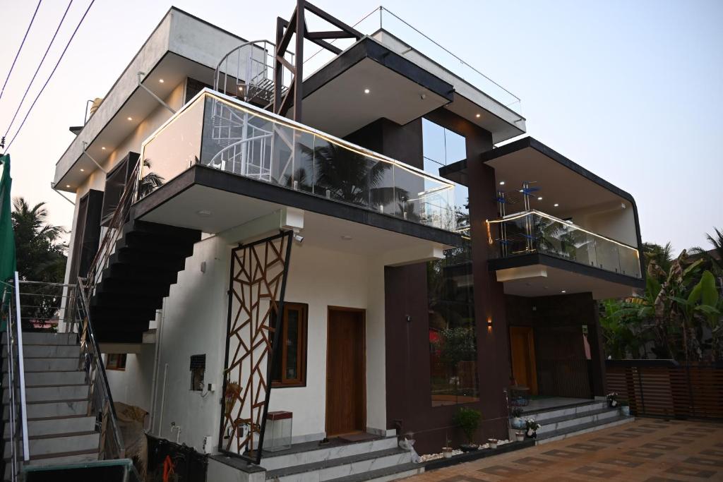 a house with two balconies and stairs on it at Barnes homestay in Kalyānpur