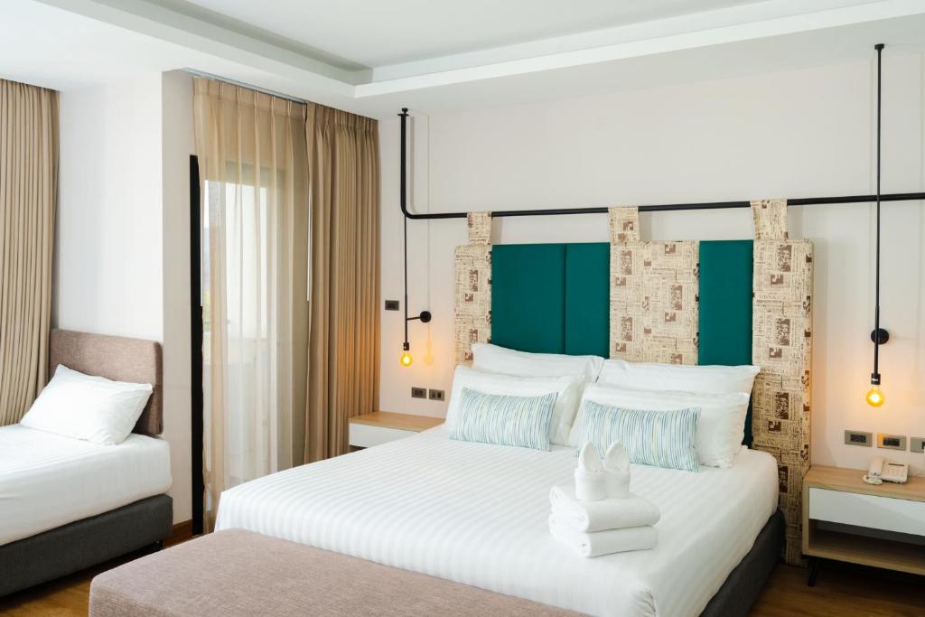 Postel nebo postele na pokoji v ubytování W3 Hotel