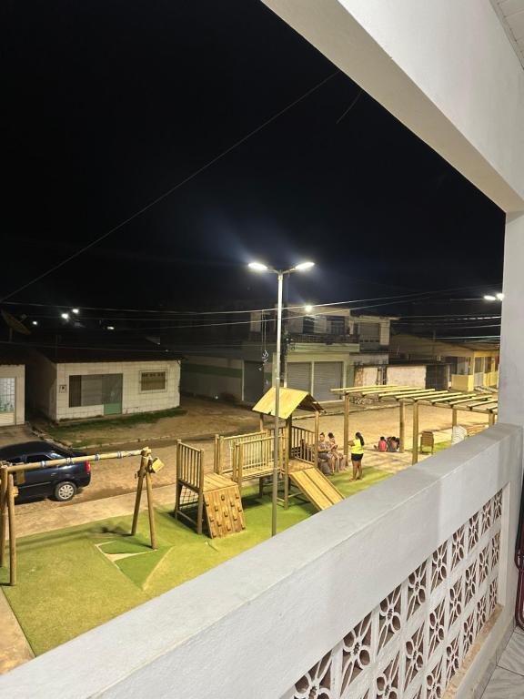a view of a playground at night at Primeiro andar charmoso in Maragogi