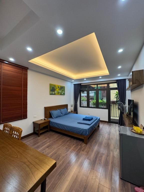 a bedroom with a bed and a table in a room at 54 homestay Van Mieu in Hanoi