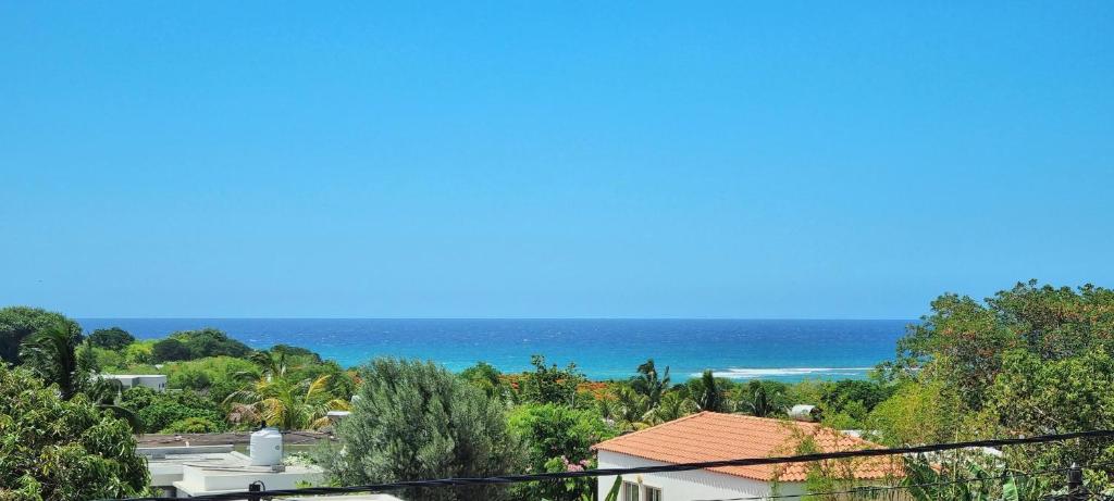 a view of the ocean from a house at Studio 21-Abiki Mauritius with Tourism Authority permit in Albion
