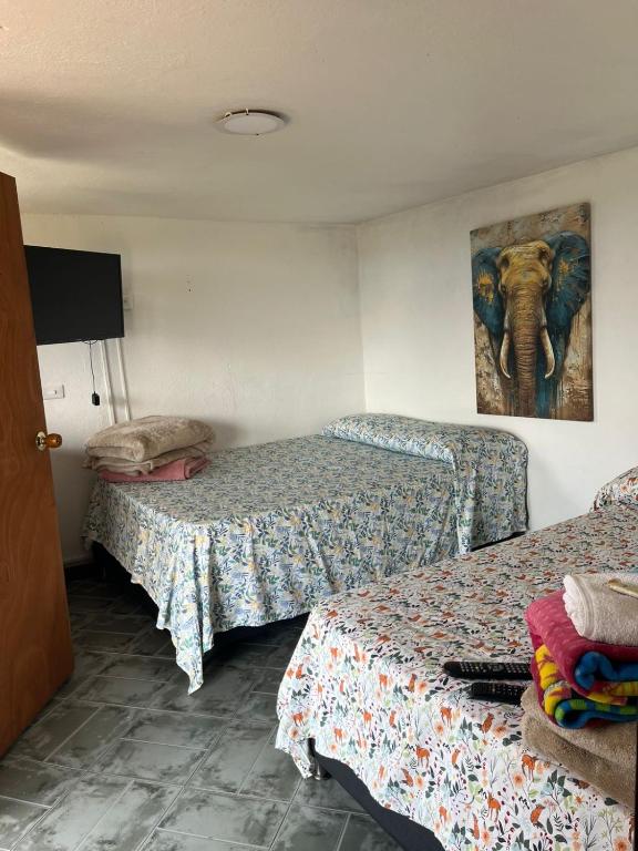 Postel nebo postele na pokoji v ubytování Hostal Inn II Rionegro