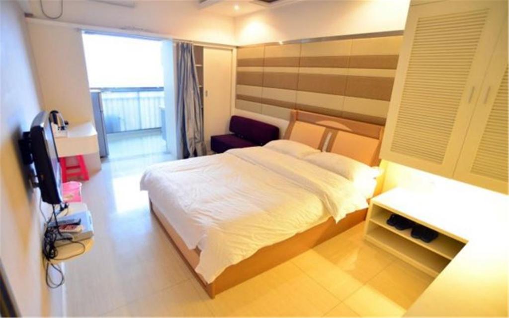 Postel nebo postele na pokoji v ubytování Nanning Qingzhou Rental Apartments