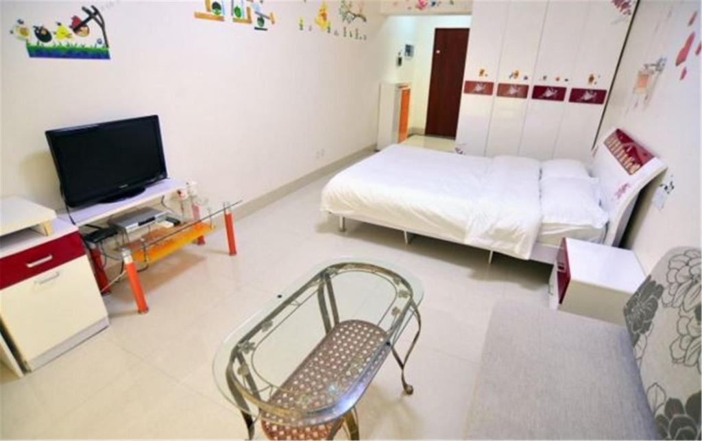 Postel nebo postele na pokoji v ubytování Nanning Qingzhou Rental Apartments