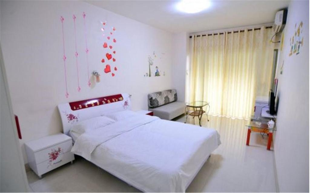 Postel nebo postele na pokoji v ubytování Nanning Qingzhou Rental Apartments