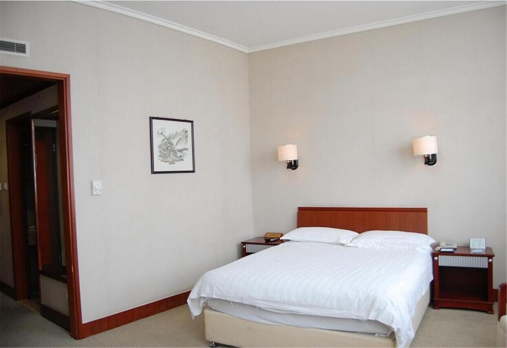 Postel nebo postele na pokoji v ubytování Nanning Qingzhou Rental Apartments