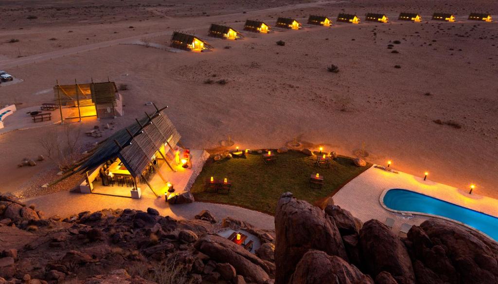 an aerial view of a house on the beach at night at Desert Quiver Camp in Sesriem