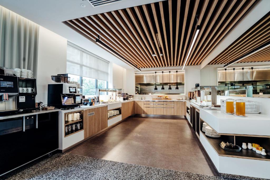 a large kitchen with wooden ceilings and a large counter at Mary MacKillop Place in Sydney