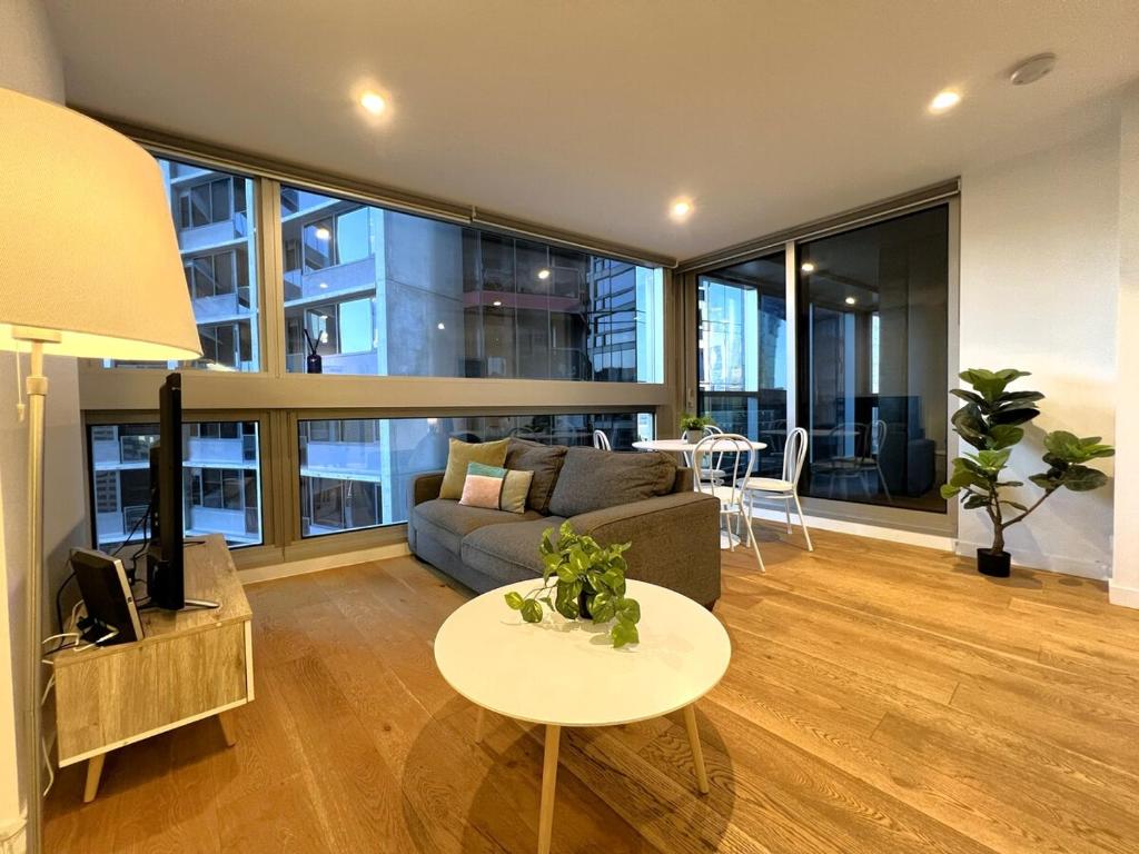 a living room with a couch and a table at 1 BR 1 BATH, Southern Cross, Balcony in Melbourne