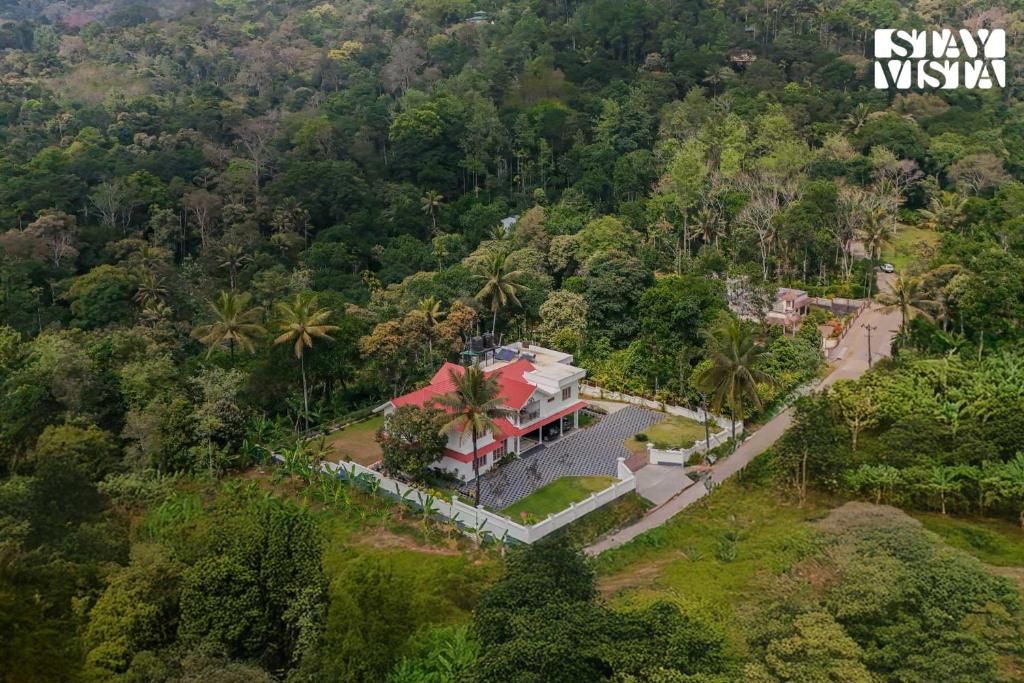 an aerial view of a house in the middle of a forest at StayVista at Spice Notes - Breakfast Included in Munnar