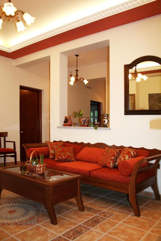 a living room with a red couch and a table at Artemis Traditional Hotel in Myrina