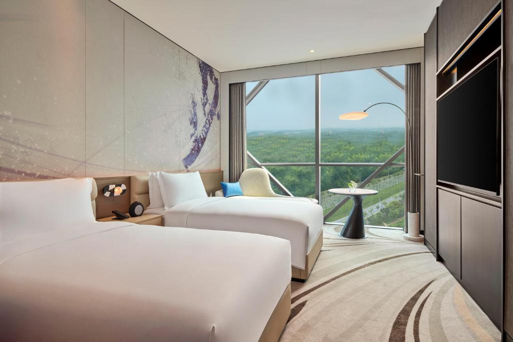 Postel nebo postele na pokoji v ubytování Crowne Plaza Shanghai Snow World by IHG