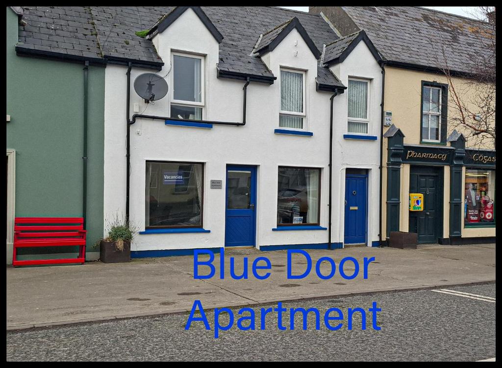 a blue door apartment building on a street at Blue Door Apartment Main St, Carrigart, F92HC04 in Carrigart