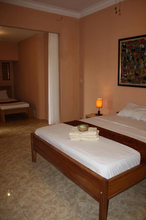 Giường trong phòng chung tại Ada Waktu Homestay