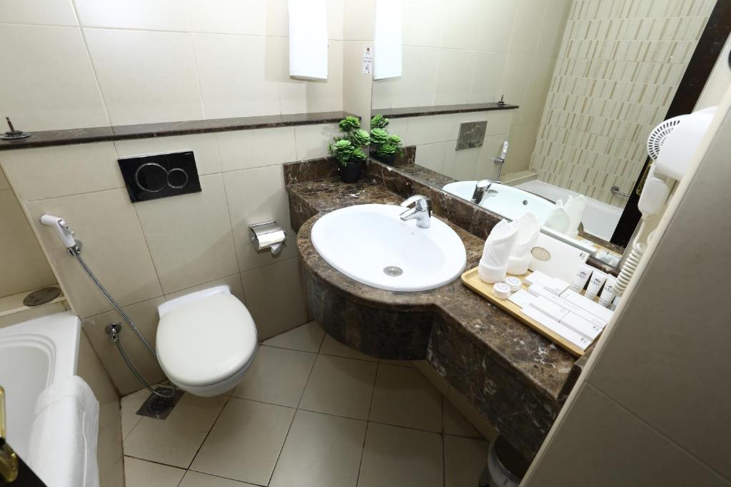 a bathroom with a sink and a toilet at Naif Fort Hotel in Dubai