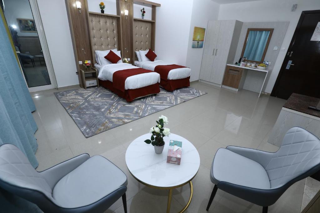 a hotel room with a bed and a table and chairs at Naif Fort Hotel in Dubai