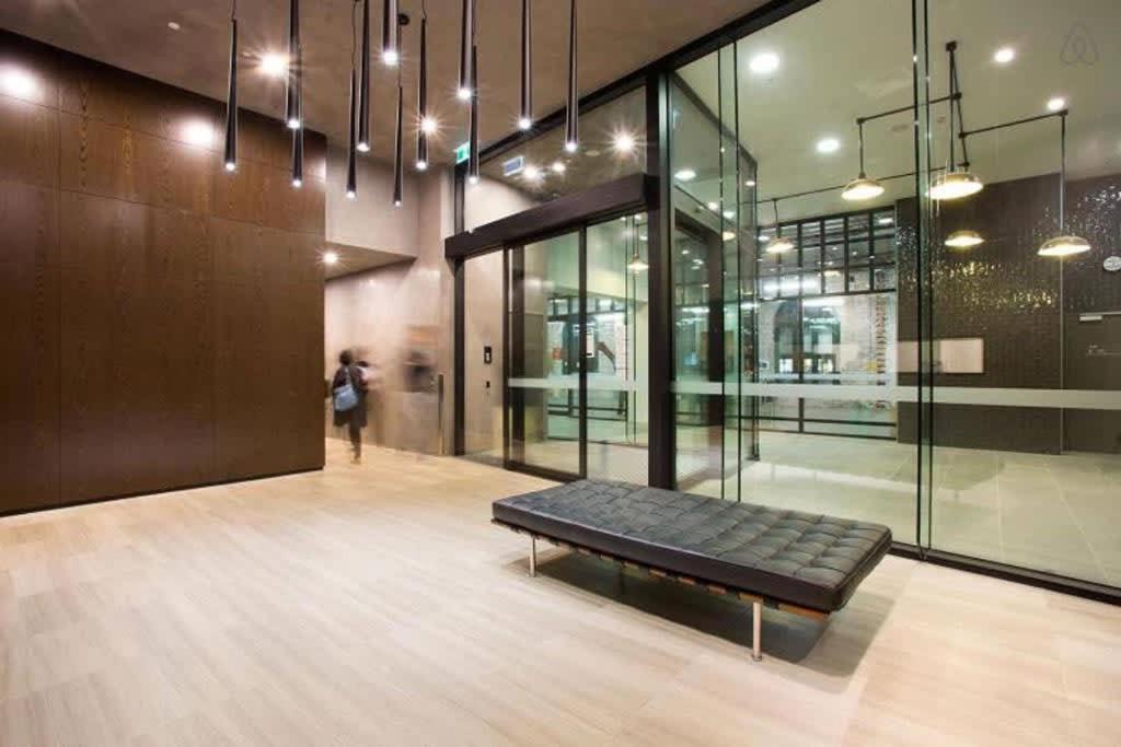 a room with a bench in the middle of a building at A 2BR Apt with Harbour Views and FREE Parking in Melbourne