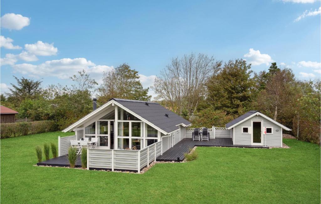 a large white house on a green lawn at Amazing Home In Tarm With Wifi in Tarm