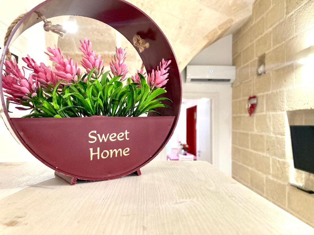 a pink flower pot sitting on a counter in a mirror at Antica Pietra in Polignano a Mare