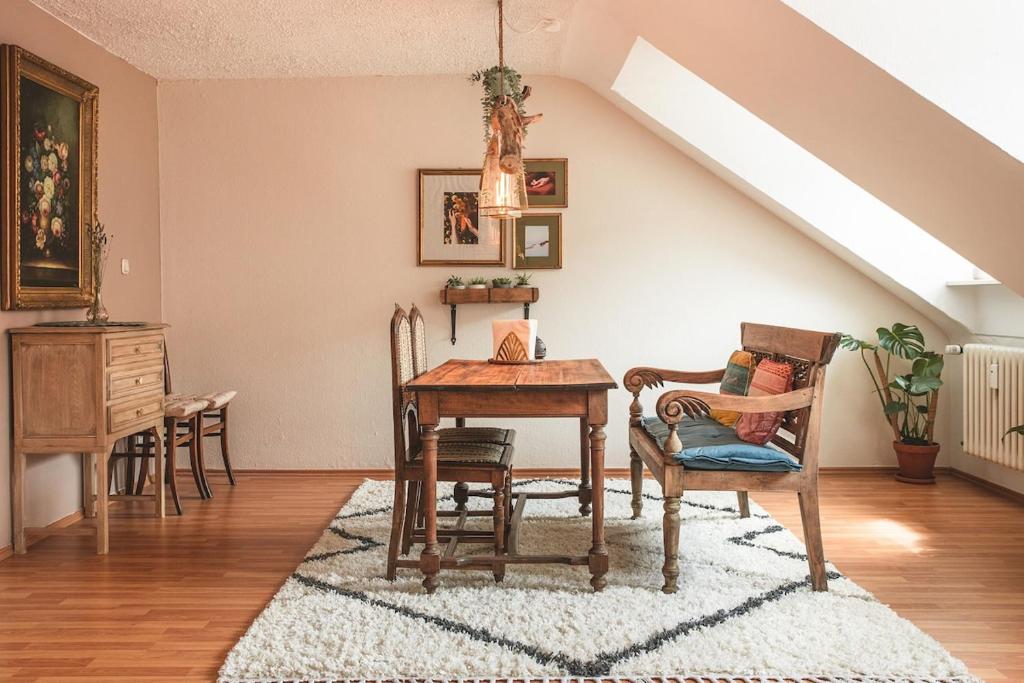 a dining room with a table and chairs in a attic at Sam & Karo Boutique Apartment in Trier