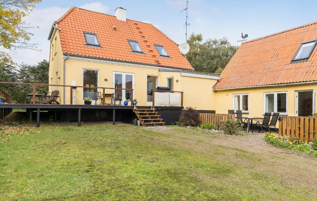 a house with a deck in the yard at Beach Front Home In Svaneke With Wifi in Svaneke