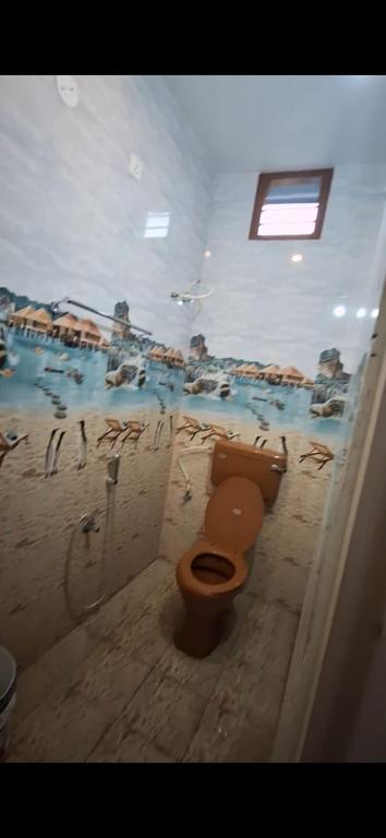 a bathroom with a toilet and a bath tub at Subramanya Residency in Thiruchendur