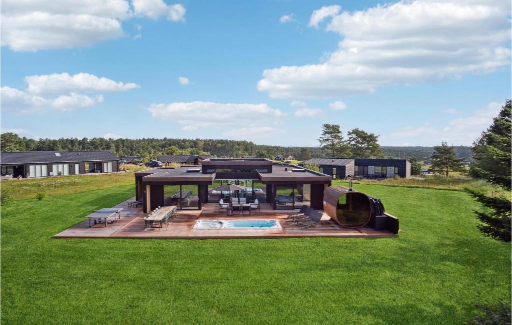 a large backyard with a pool and a house at Gorgeous Home In Ebeltoft With Kitchen in Ebeltoft