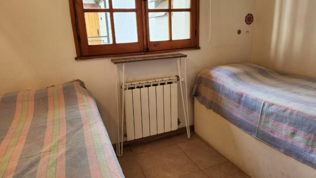 Ένα ή περισσότερα κρεβάτια σε δωμάτιο στο dpto aldea de motaña