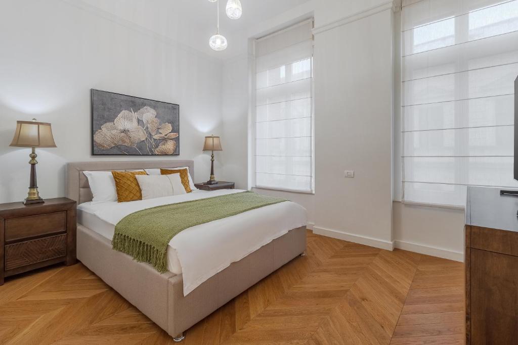 a white bedroom with a bed and two windows at SUPREME Experience Markovitsz-Palat Istoric-Elegant & Spațios in Oradea