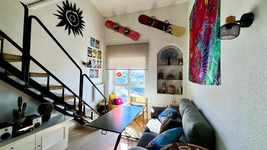 a living room with a couch and a staircase at Estupendo Dúplex en Sierra Nevada in Monachil