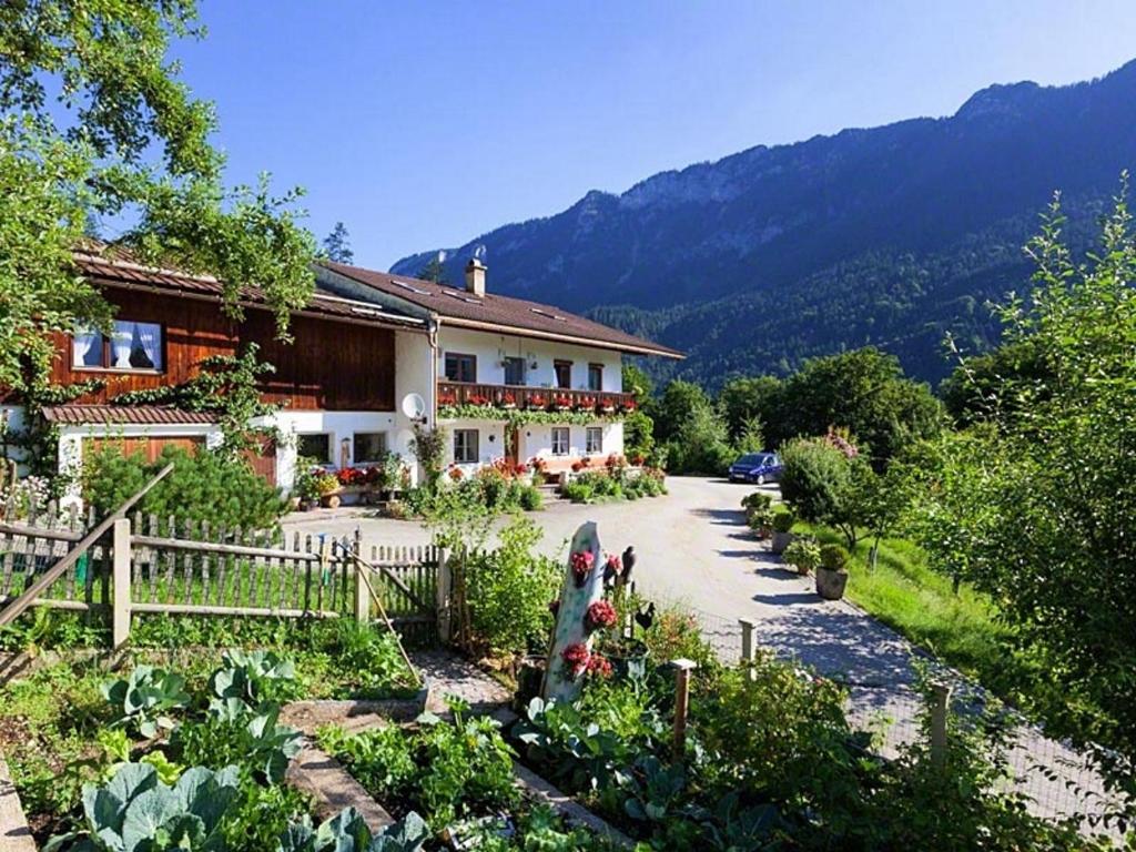 a house with a garden in front of it at Pension Scheuerbichl in Bischofswiesen