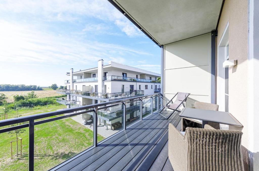 a balcony with a view of a house at Alte Seefahrtschule App 33 "Oberdeck" in Wustrow