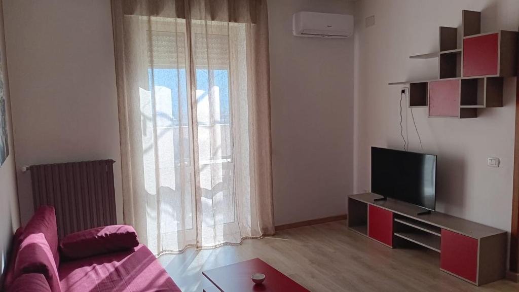 A television and/or entertainment centre at Renovated Loft with Vesuvio view terrace