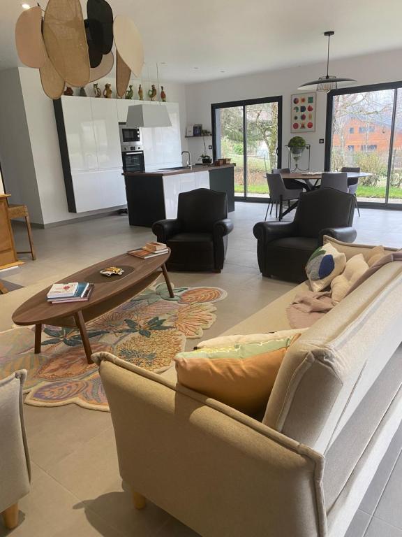 a living room with a couch and a table at Maison paisible proche du centre in Besançon