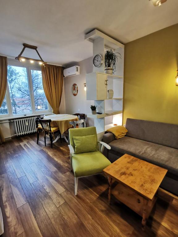 a living room with a couch and a table at Апартамент Център in Vratsa