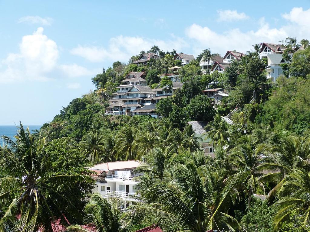 a bunch of houses on a hill with palm trees at Sulu Sea Boutique Hotel in Boracay