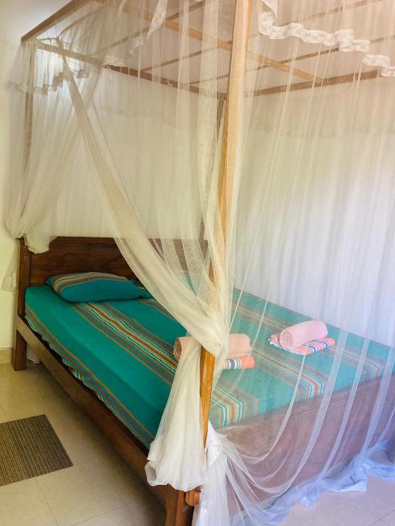 Postel nebo postele na pokoji v ubytování Ameena Homestay