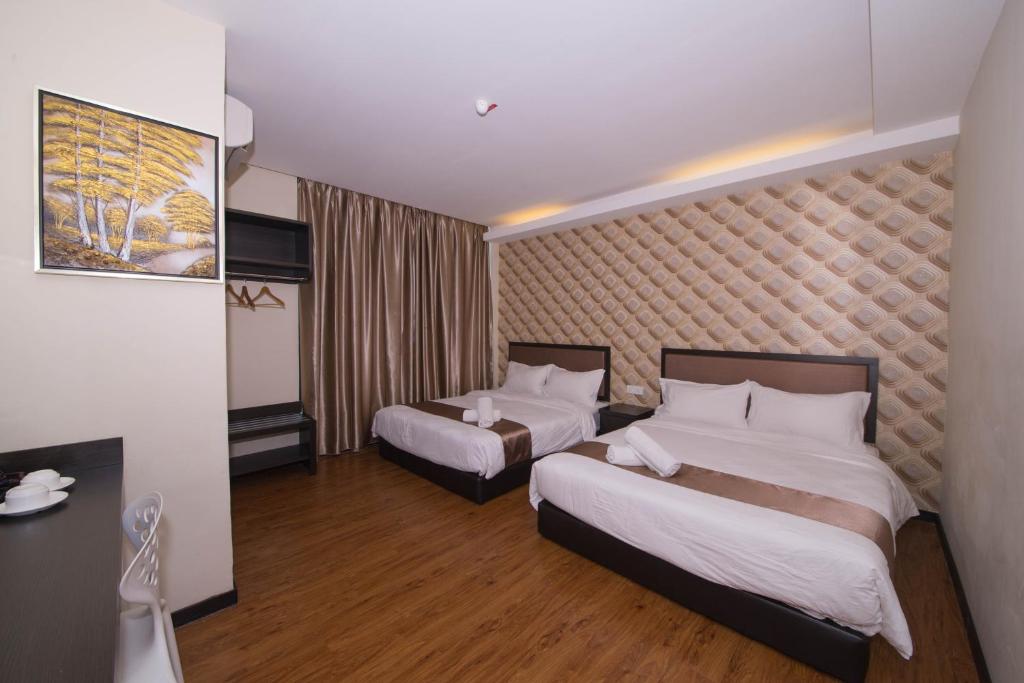 Postel nebo postele na pokoji v ubytování ORO Hotel Kluang