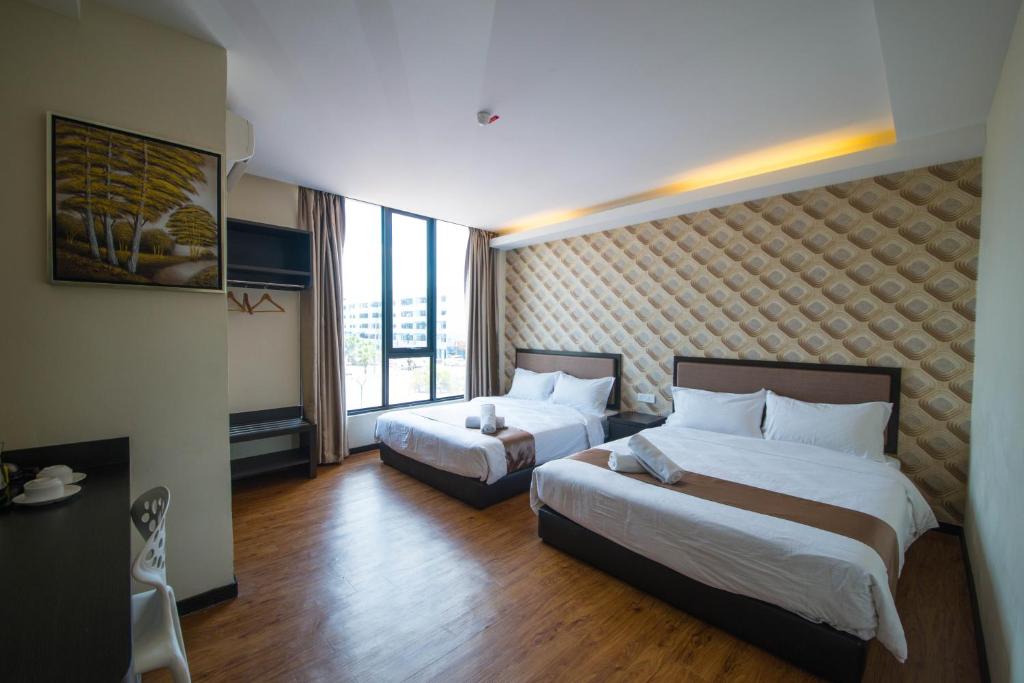 Postel nebo postele na pokoji v ubytování ORO Hotel Kluang