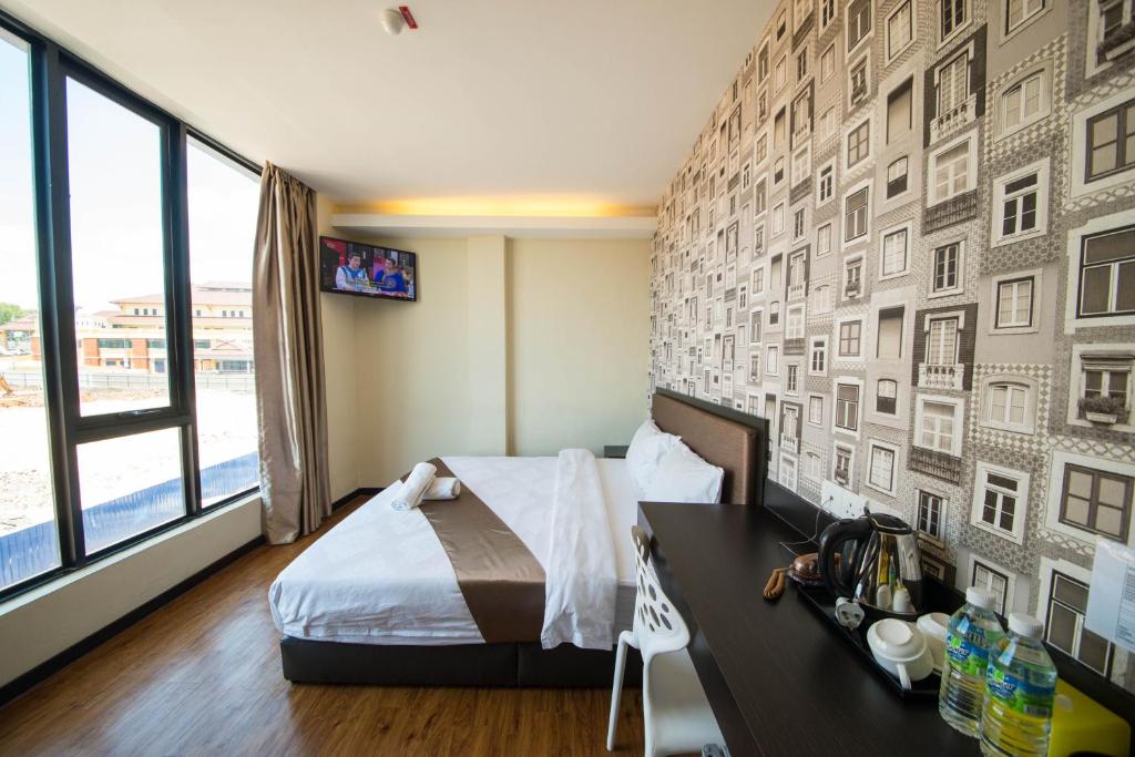Postel nebo postele na pokoji v ubytování ORO Hotel Kluang