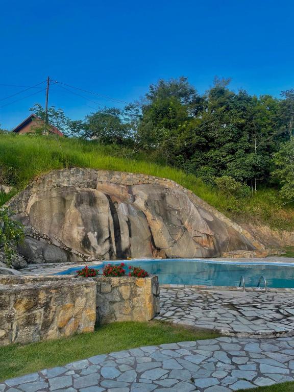 a rock retaining wall next to a swimming pool at Chã Grande - Cantinho Premium in Chã Grande