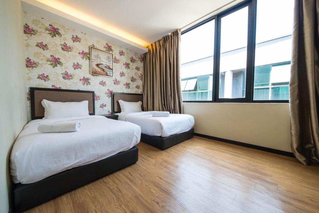 Postel nebo postele na pokoji v ubytování ORO Hotel Kluang