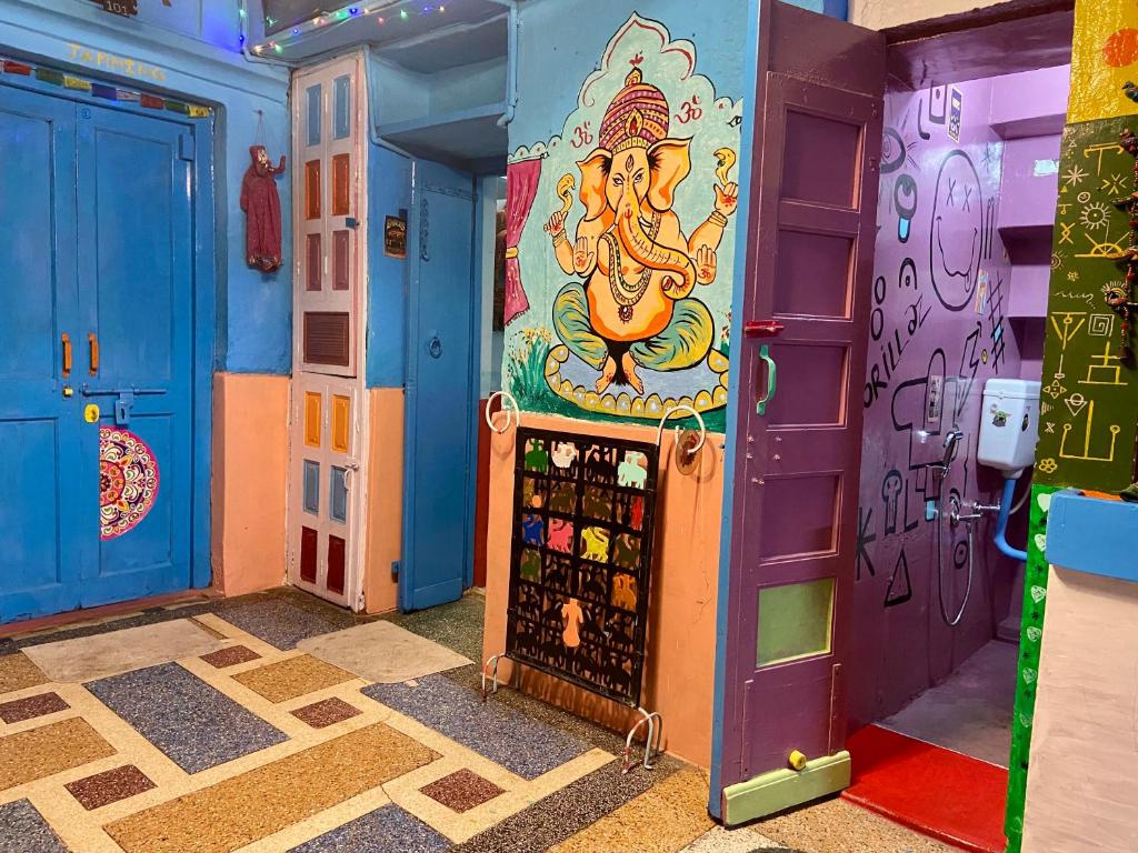 a room with colorful doors and a painting on the wall at Bob hostel in Jodhpur