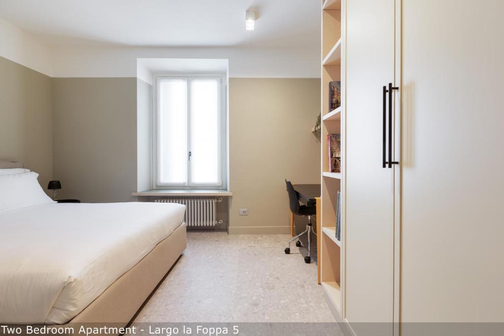 Posteľ alebo postele v izbe v ubytovaní Brera Apartments in Moscova