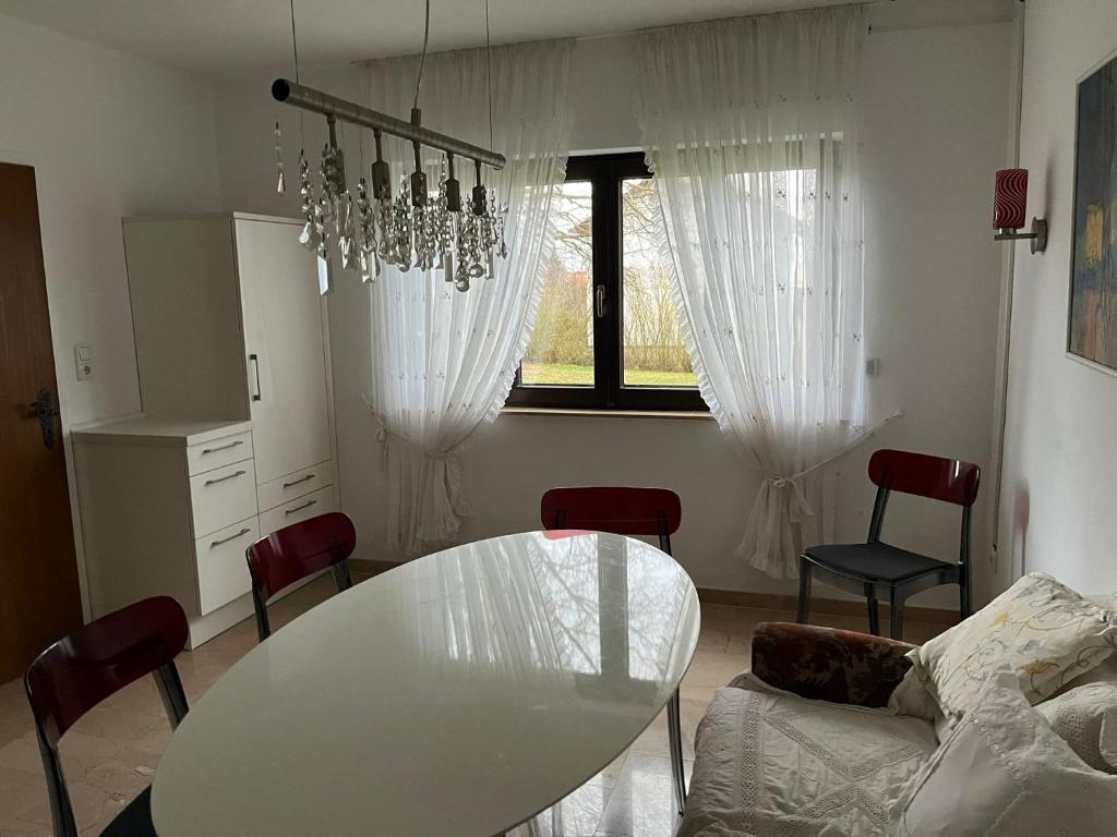 a living room with a white table and chairs at Villa Sommer in Germerode