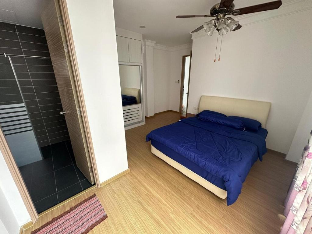 a bedroom with a blue bed and a shower at Lp Homestay Miri in Miri