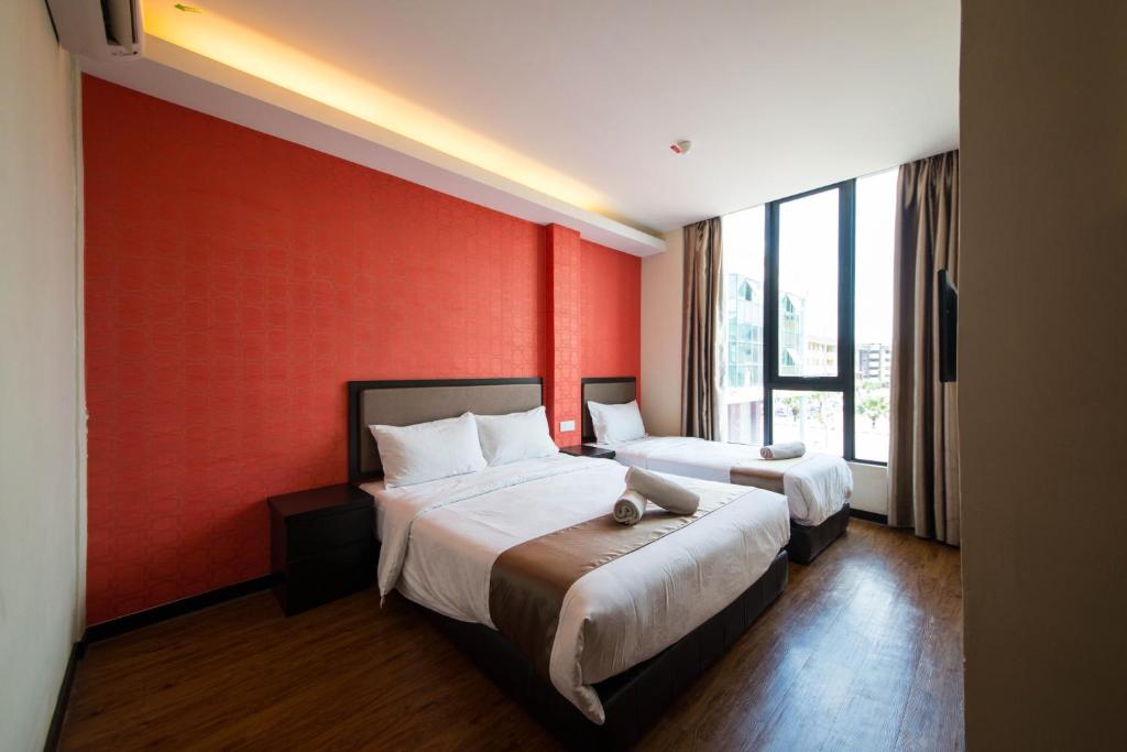 Postel nebo postele na pokoji v ubytování ORO Hotel Kluang