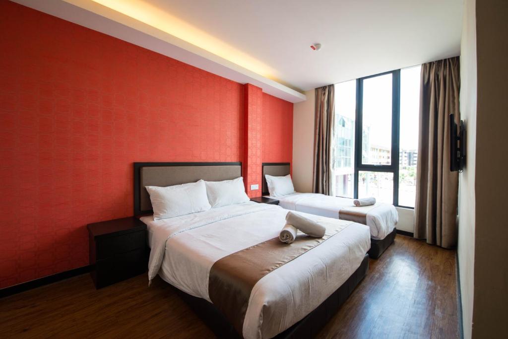 Postel nebo postele na pokoji v ubytování ORO Hotel Kluang